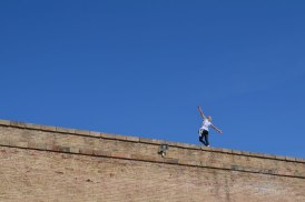 Balancing woman on wall